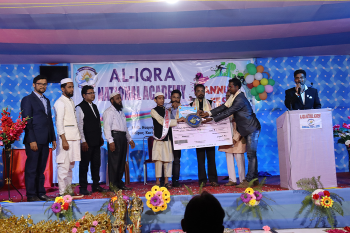 AQM Ayatullah student of AINA receiving Highest Attendance Award